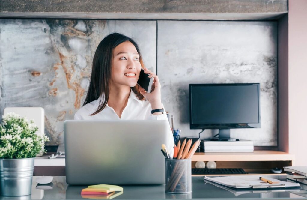 A Woman Sitting in Front of a Laptop Screen