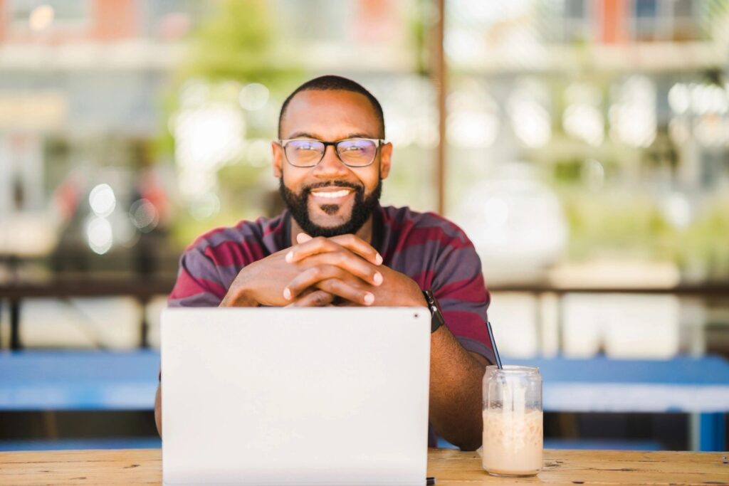 Smiling SDR in front of laptop